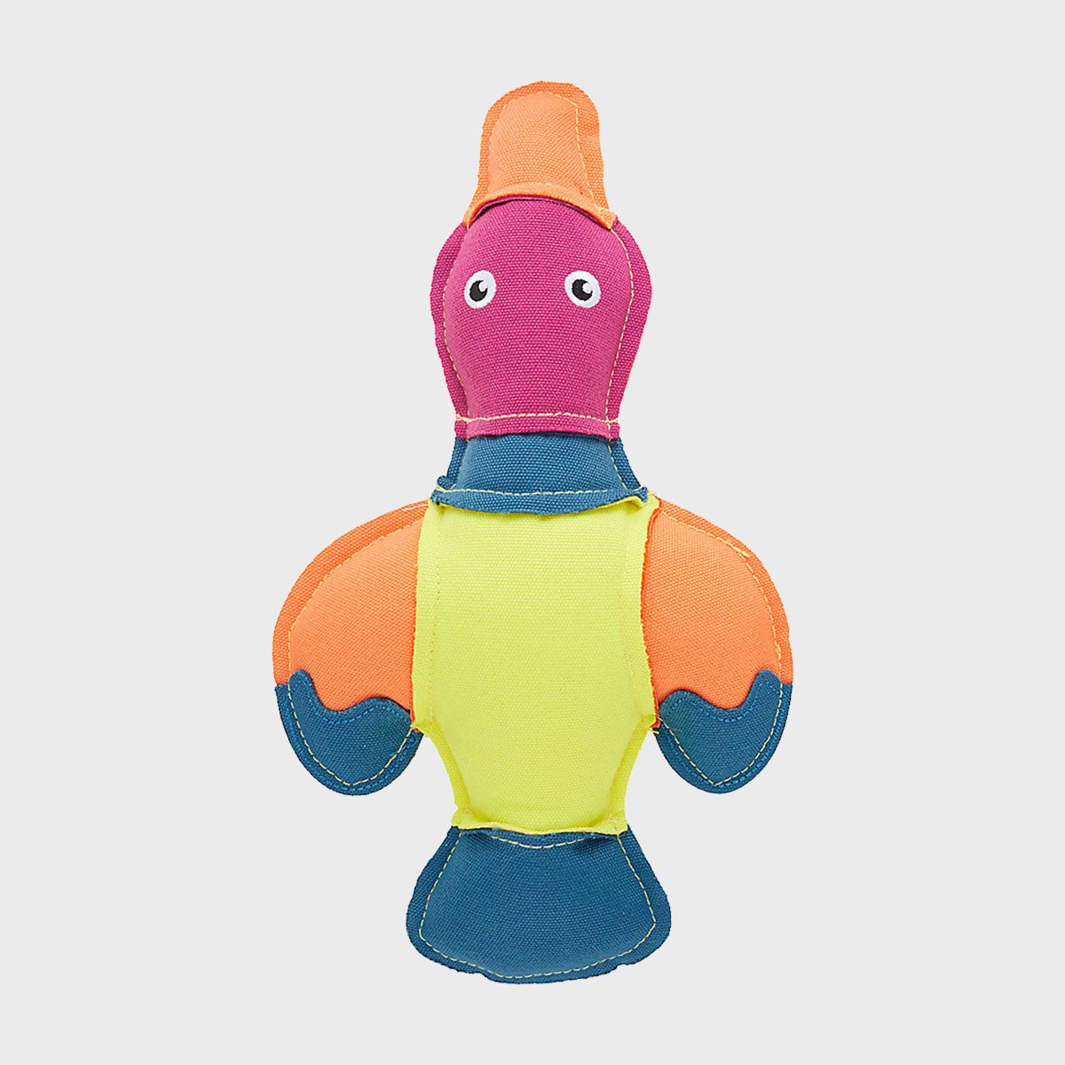 Colorful fabric bird toy sits against a plain background, featuring orange, blue, and pink patches with googly eyes and abstract design.