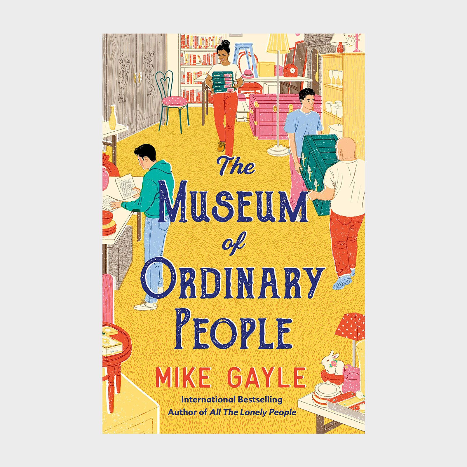 People carry boxes in a cozy, decorated room with colorful furniture and shelves. "The Museum of Ordinary People" by Mike Gayle is the title.