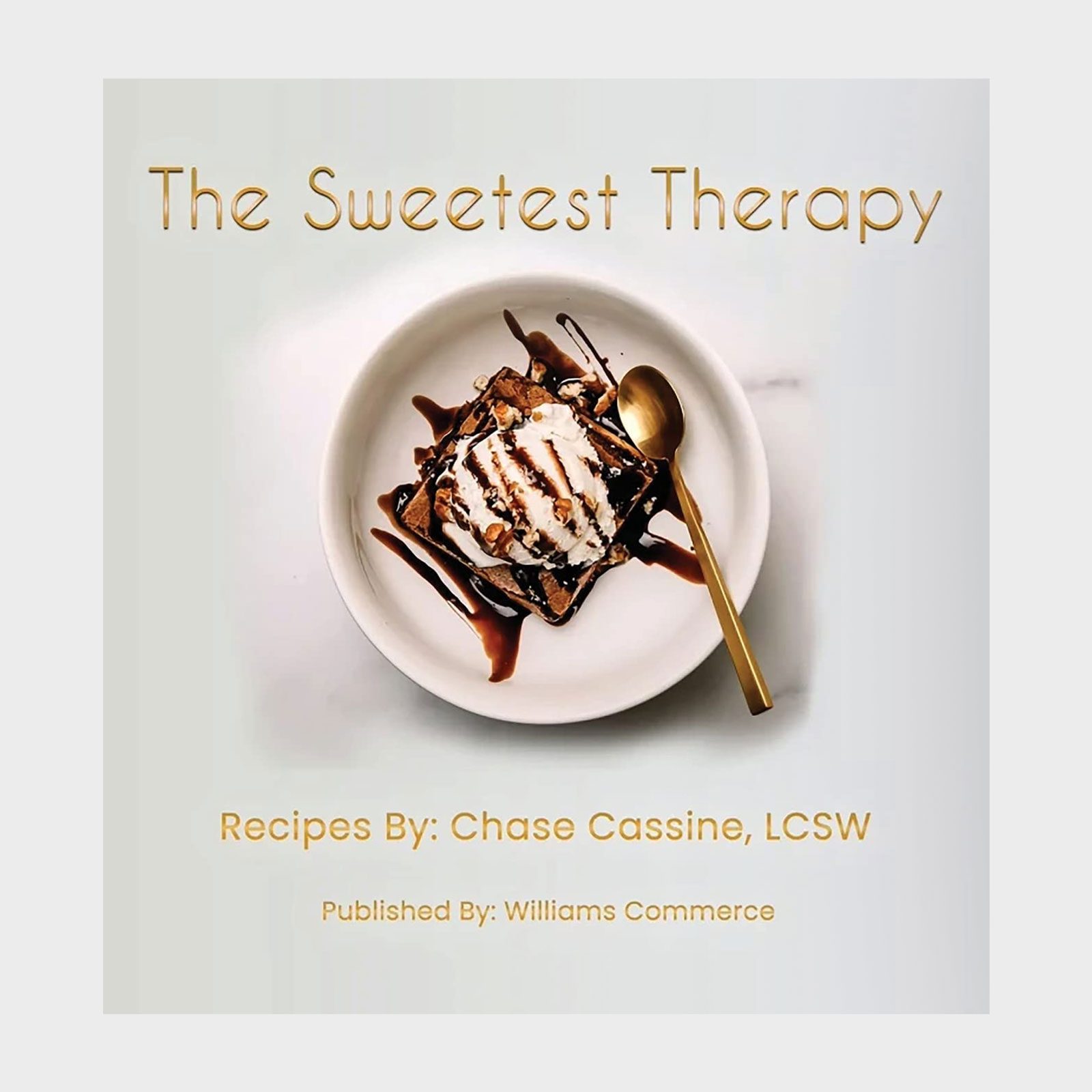Dessert topped with whipped cream and chocolate syrup sits in a bowl with a gold spoon. Text reads, "The Sweetest Therapy," and details the author.
