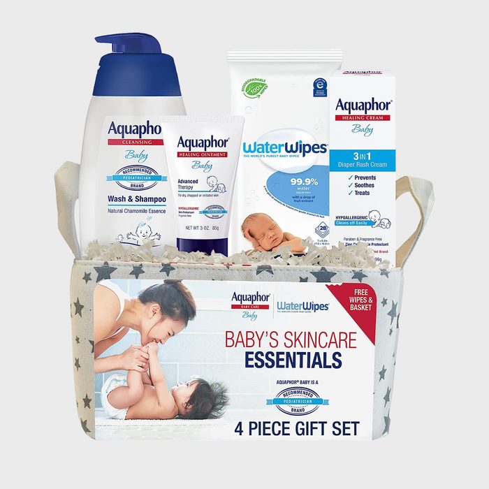 Gift basket holding baby skincare products sits against a simple background, featuring Aquaphor bottles and WaterWipes package, highlighting 