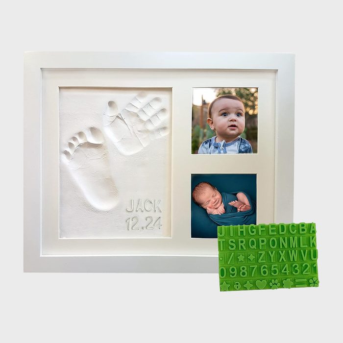 Frame displays baby hand and foot imprints; photos of a baby above, a neonate below; green alphabet letter set nearby. Text reads 