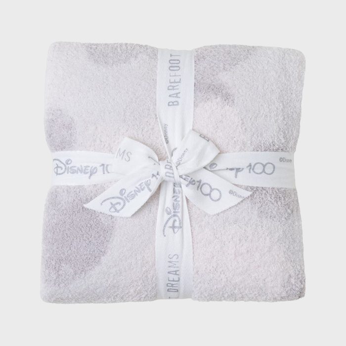 A folded blanket wrapped in a ribbon with 