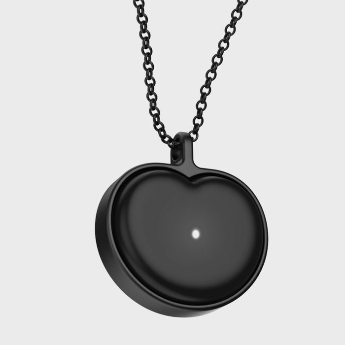 Heart-shaped black locket, hanging with a dark chain, set against a plain light background.