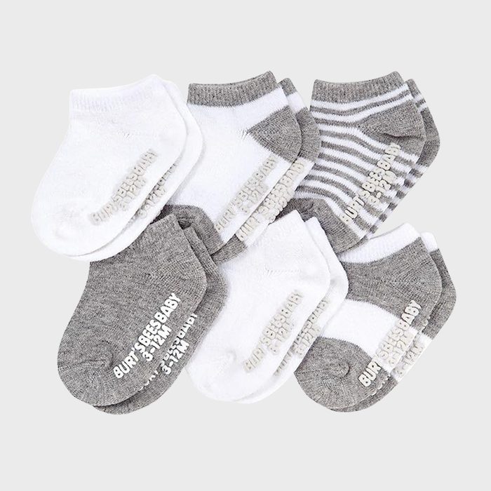 Six pairs of baby socks, in gray and white, are arranged overlapping. Each has the text 