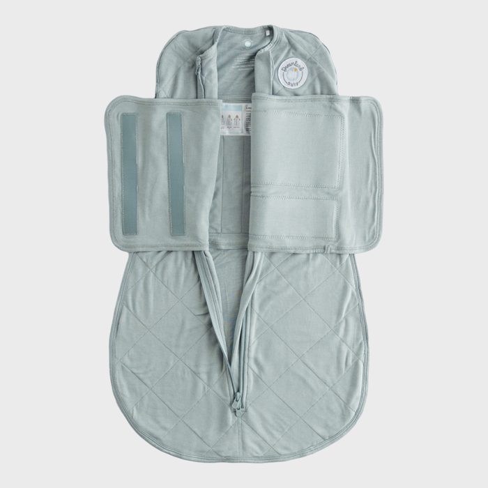 Green quilted swaddle blanket lies open on a white background, featuring Velcro straps and a zipper down the middle.