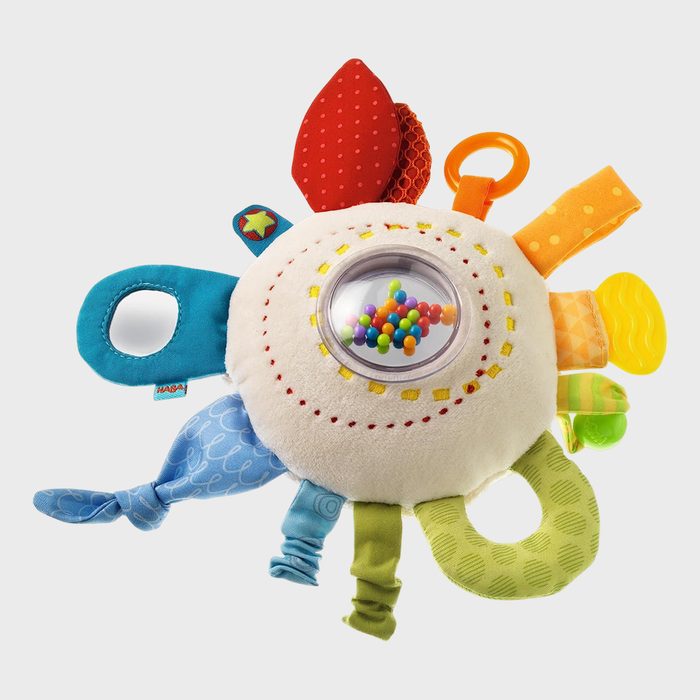 Toy with colorful tabs and a central transparent rattle contains multicolored beads, providing a tactile and auditory sensory experience in a playful setting.