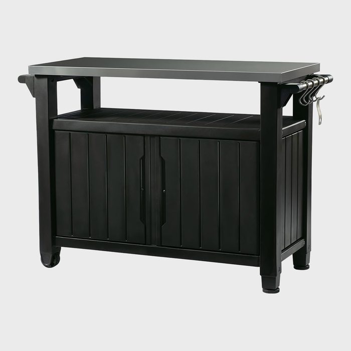 A black storage cabinet stands with hooks on the side, positioned against a plain background.