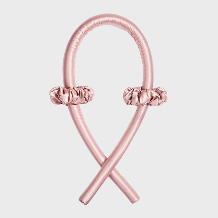Pink, satin-covered rod forms a loop with two scrunchies, set against a plain gray background.