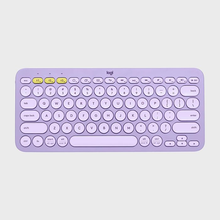 Purple wireless keyboard with round keys, displaying a QWERTY layout. It features yellow function keys, set against a plain grey background.