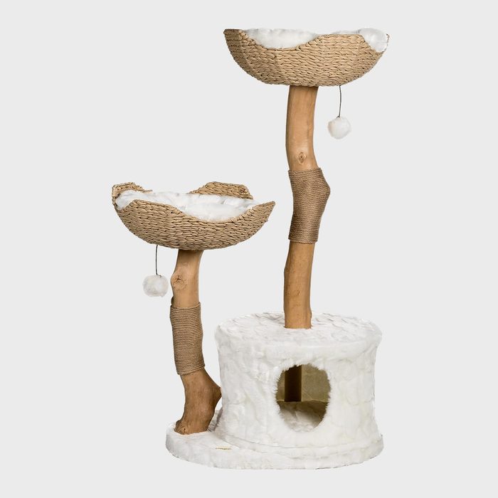 Cat tree structure with two woven baskets and dangling toys, supported by wooden posts. It's placed on a plush, circular base indoors.