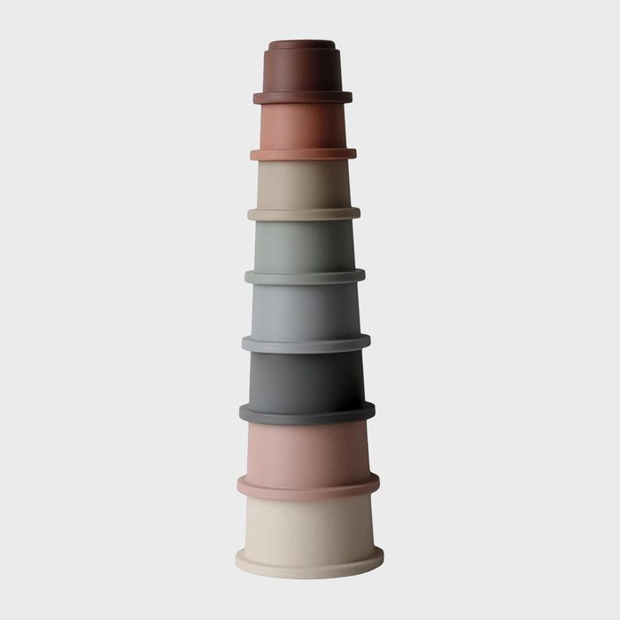Stacked multicolored cups tower vertically, forming a gradient, on a plain white background.