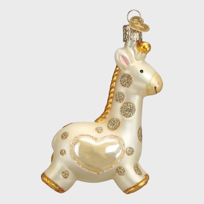 Glass giraffe ornament, adorned with glittery spots and a heart, hangs individually against a plain background.