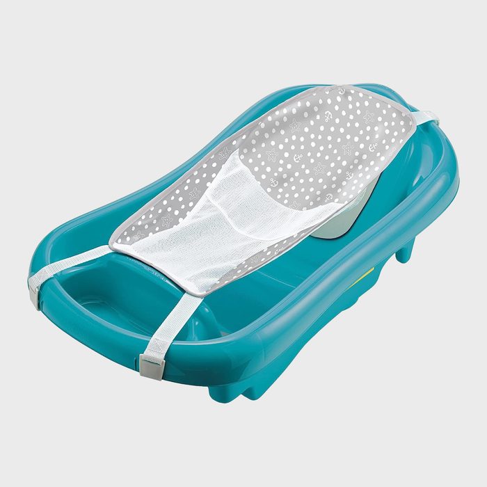 Baby bathtub holds sling, positioned for infant bathing, with a blue plastic body and a patterned gray mesh support.