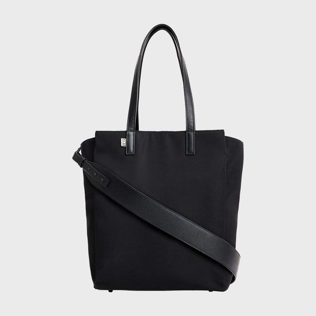 A black tote bag with dual handles and a diagonal shoulder strap, set against a plain white background.
