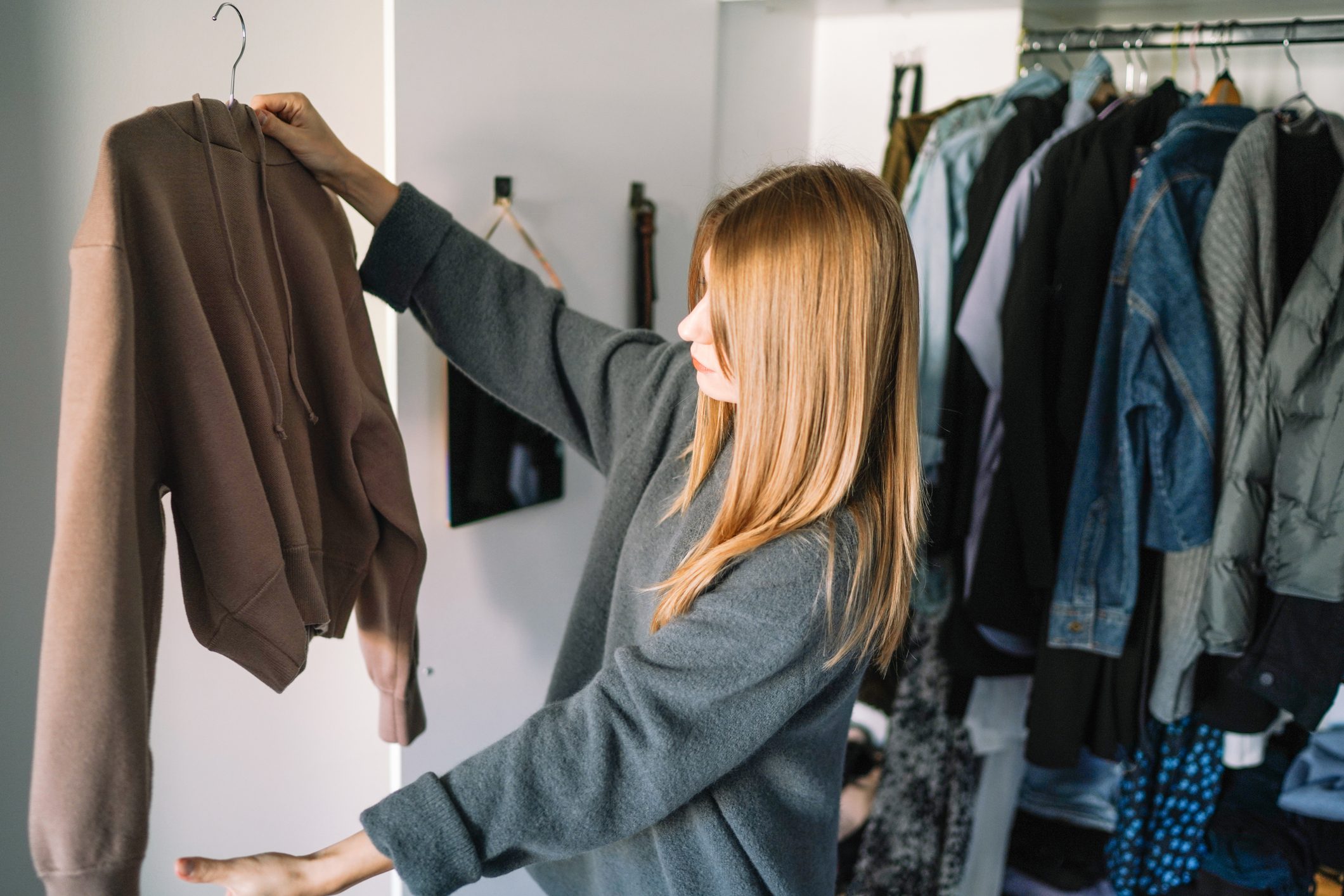 Caucasian woman organizing closet at home,Spain