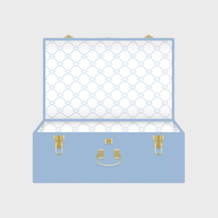 A blue suitcase stands open, its interior lined with a white patterned fabric featuring blue crosses, in a plain background.