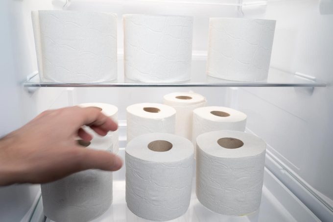 A Person Man Is Going To Take Or Leave A Roll Of Toilet Paper Inside A Refrigerator That Is Full Of Toilet Paper Rolls Concept Of Storage In Times Of Pandemic In A Humorous Way