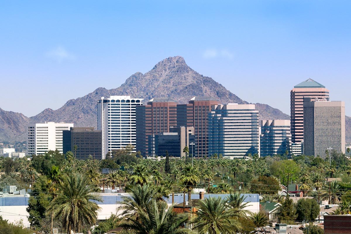 Downtown Scottsdale And Suburbs Of Phoenix with the White Tank Mountain Range in the background on a bright blue sky day