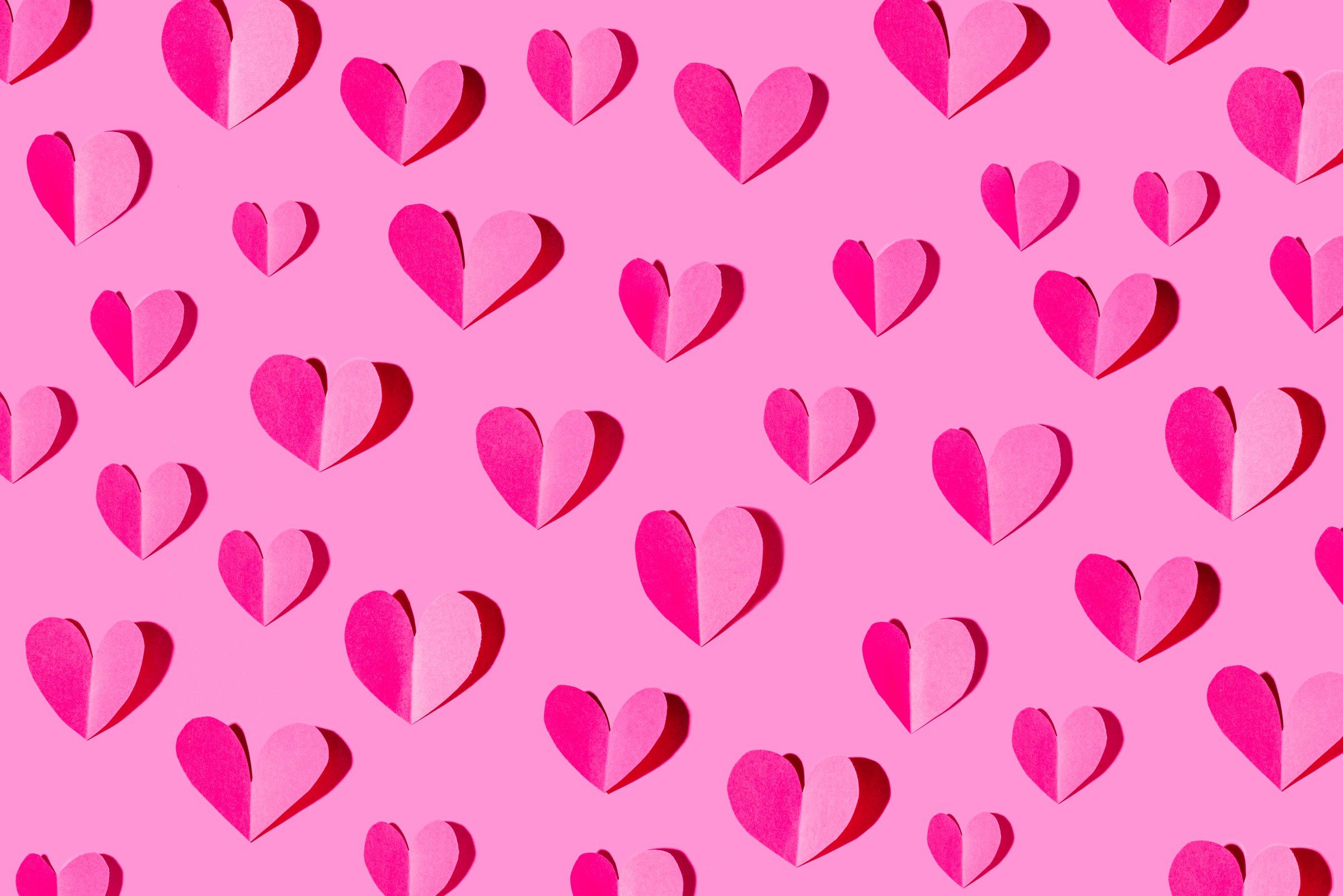 Paper craft with heart pattern on pink background
