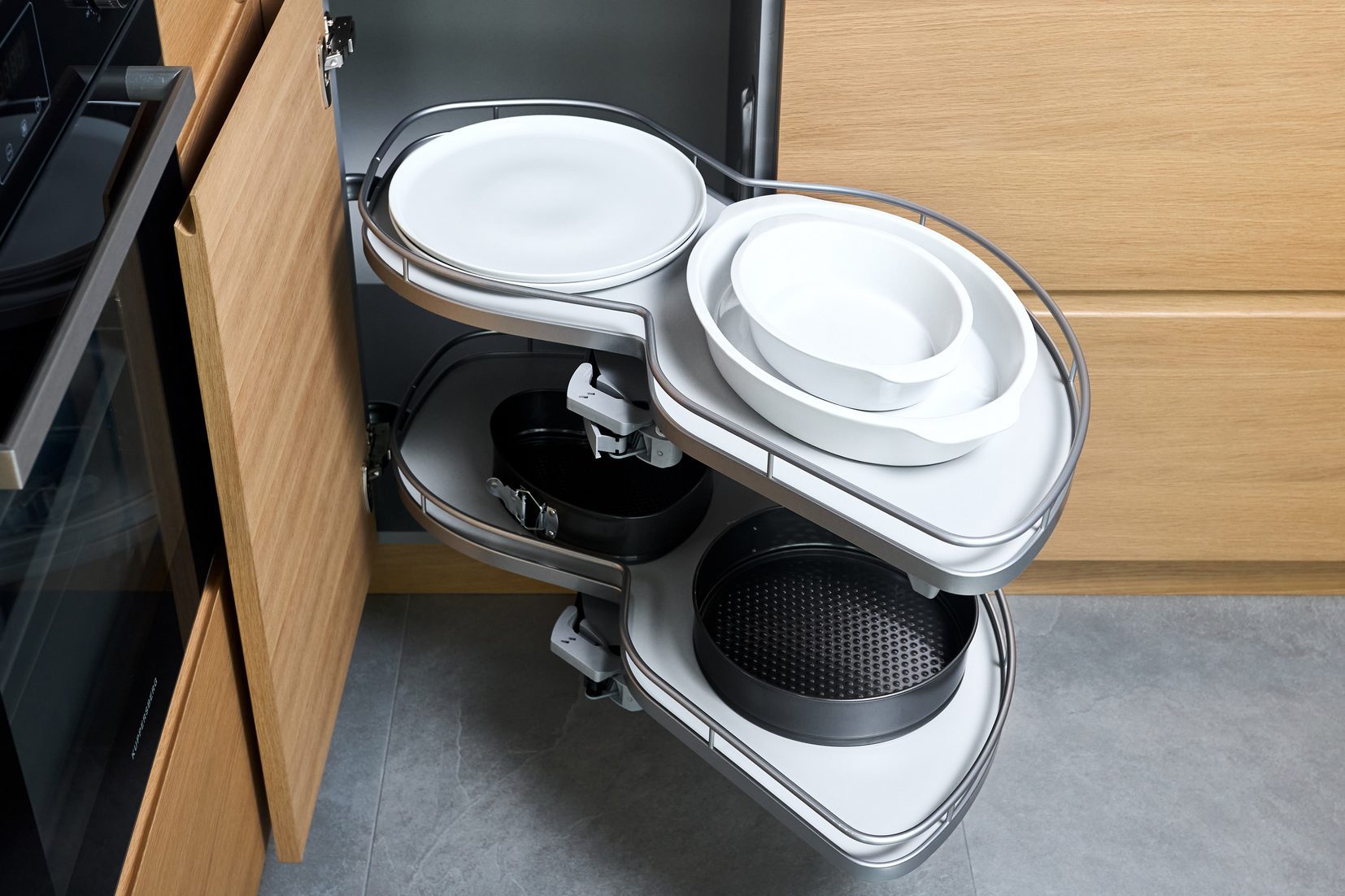 Kitchen access mechanism Magic corner for Blind Corner Cabinets. Solution for a kitchen corner storage in cupboard. Corner unit with pull out shelves for cookware.