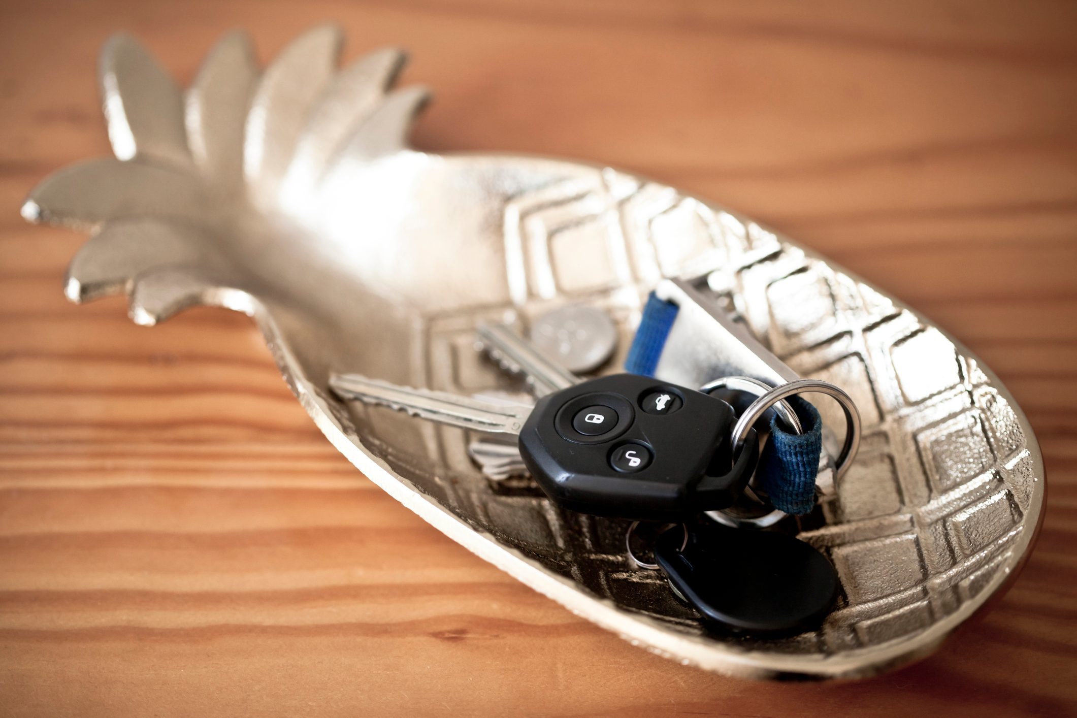 Set of keys in a pineapple-shaped trinket tray on kitchen counter