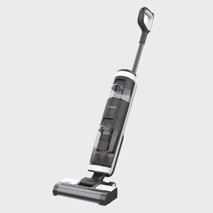 Vacuum cleaner stands upright, featuring a transparent water tank, on a plain light gray background.