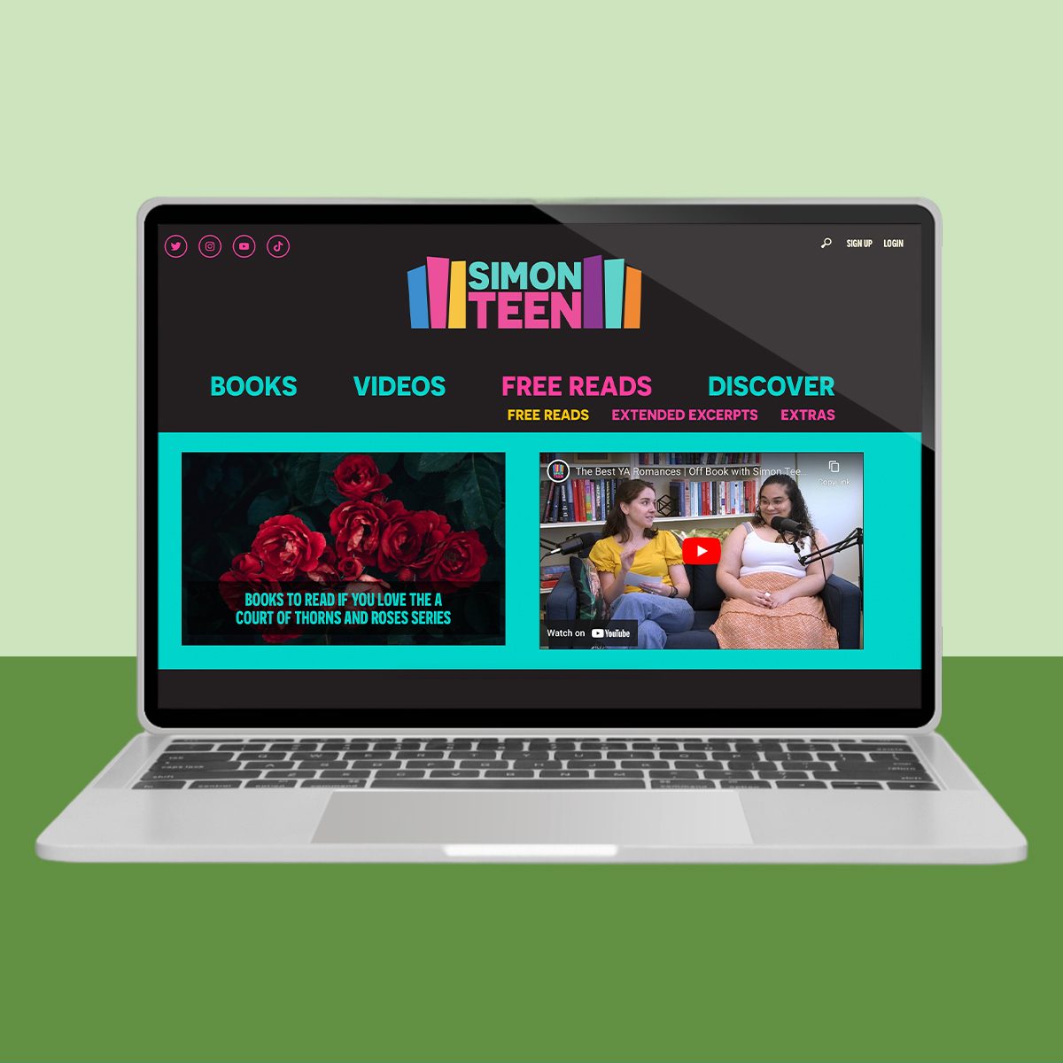 Laptop displaying a website featuring books and videos against a colorful background, with two people engaging in a discussion via video.