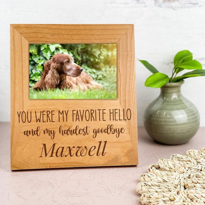Photo frame holds a dog picture; wooden frame inscribed, 