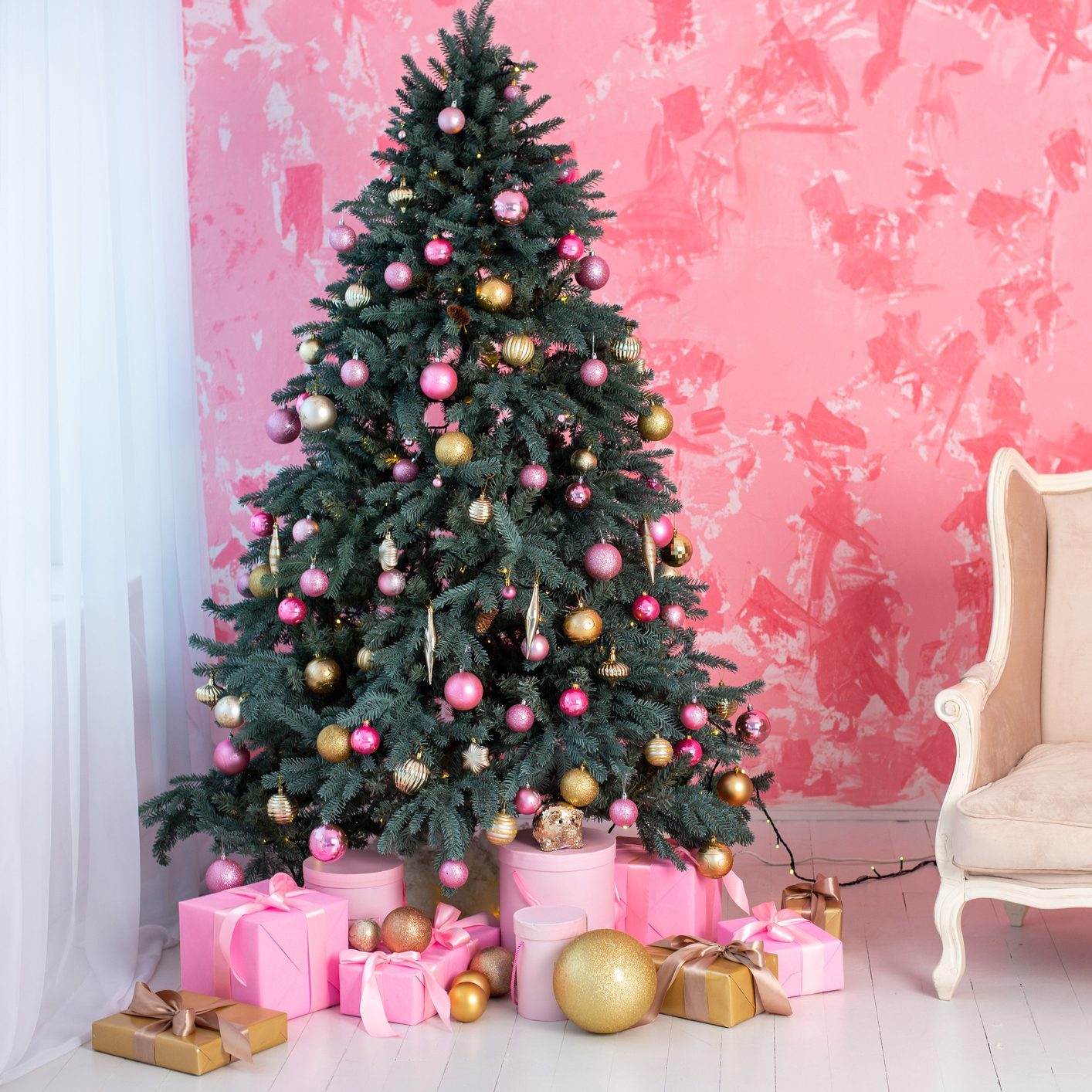 Beautiful holiday decorated room with Christmas tree and with presents. Cozy winter scene.