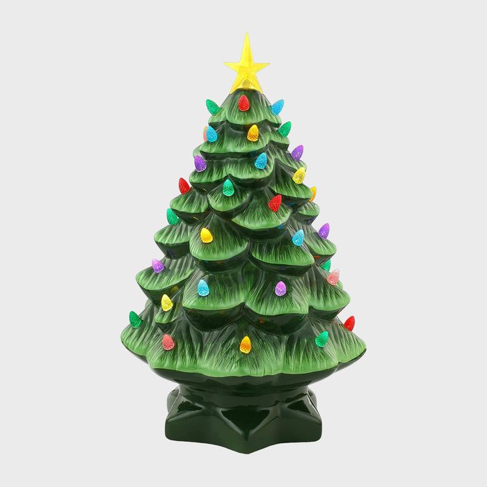 Ceramic Christmas tree displays colorful lights adorned with a yellow star, situated in a plain, neutral background.