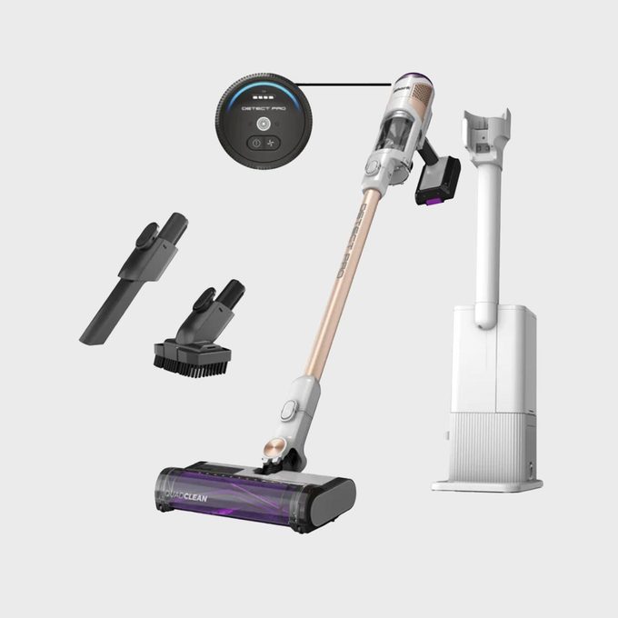 Cordless vacuum stands upright, showing attachments and charging dock. Screen displays 