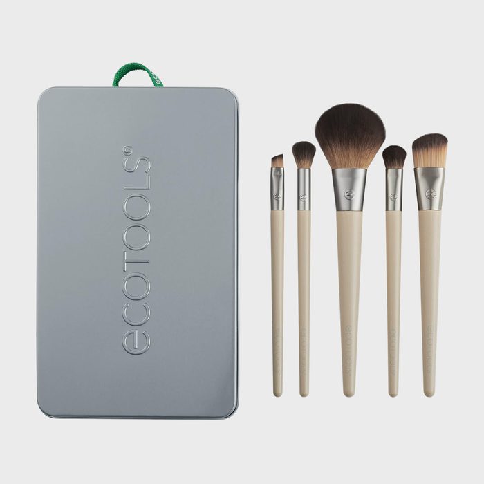 Makeup brushes displayed beside a rectangular silver case with 