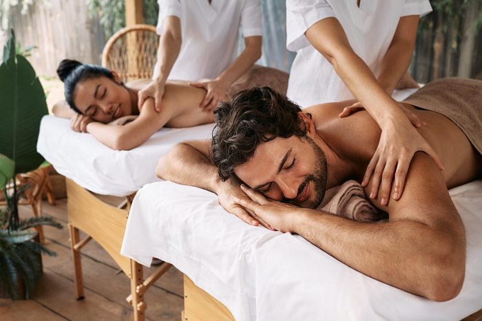 Couple massage at spa resort. Beautiful couple getting a back massage outdoor, romantic weekend and relax
