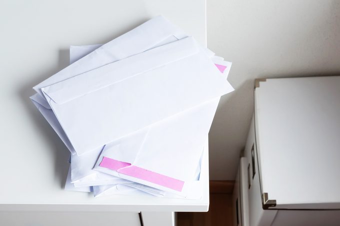 mail drop station in a kitchen with bins for recycling junk mail