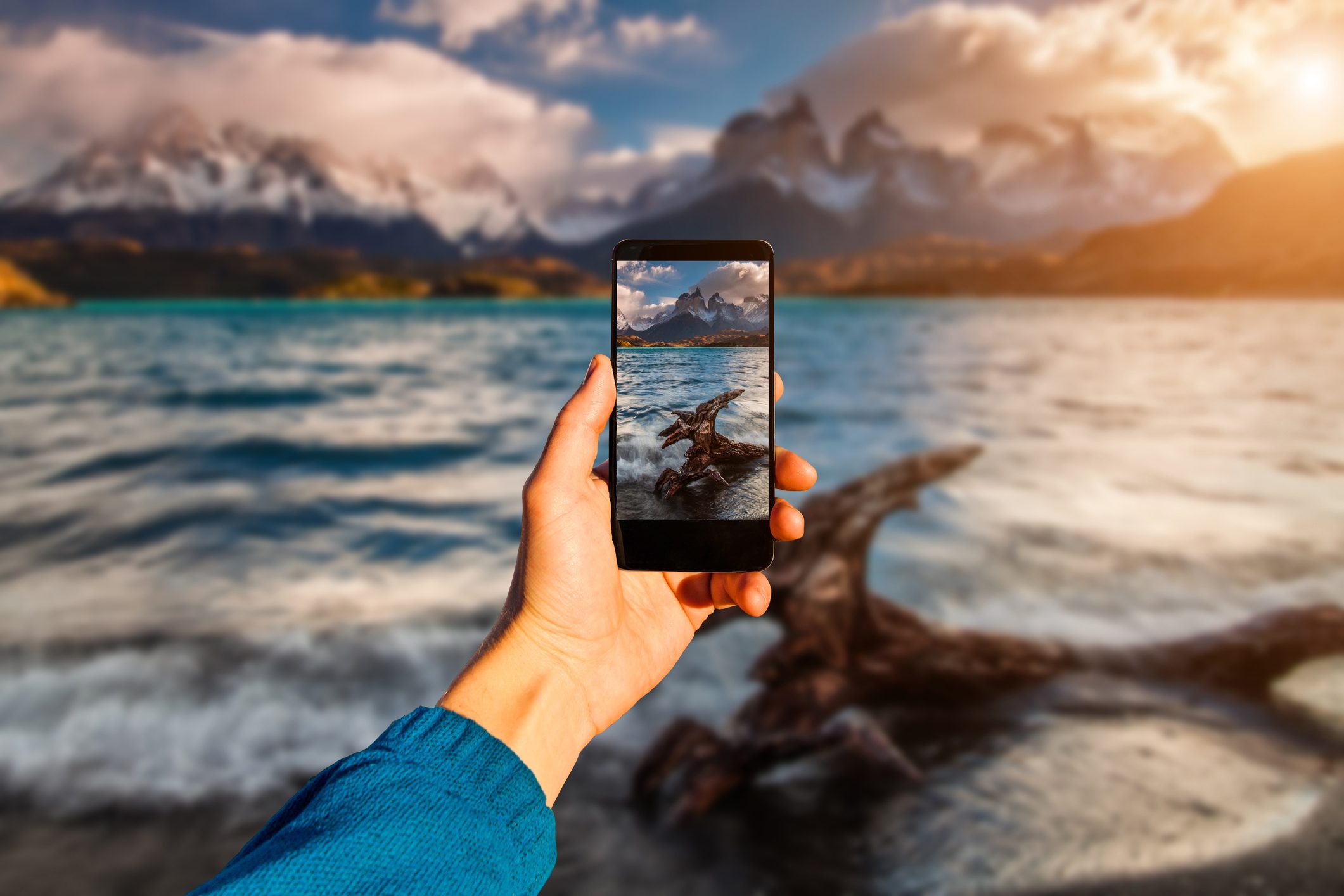 Photographing with smartphone in hand. Travel concept. Torres del Paine, Chili