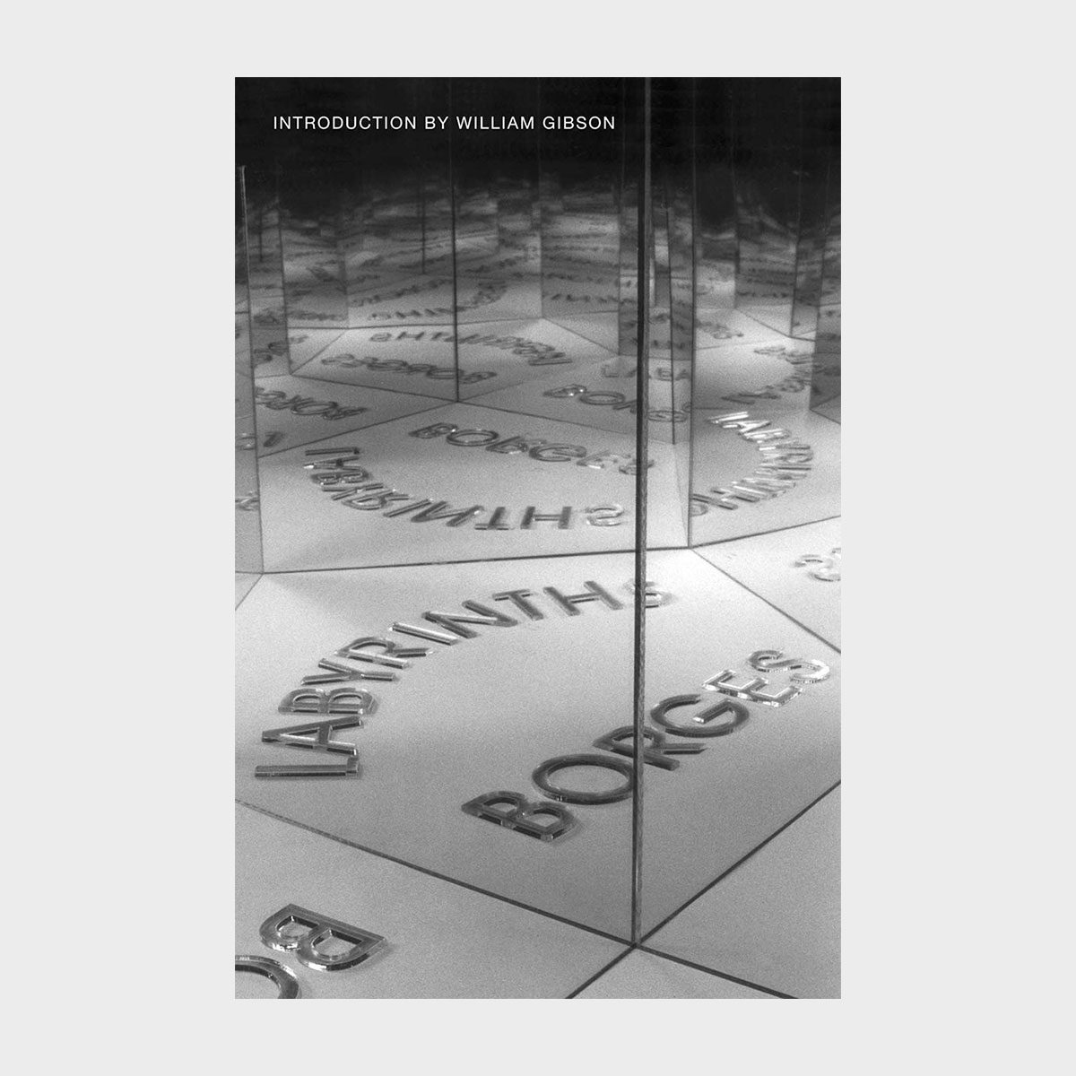 Embossed text "LABYRINTHS BORGES" reflected in mirrored surfaces creates infinite illusion. Introduction by William Gibson visible above in a minimalist, abstract setting.