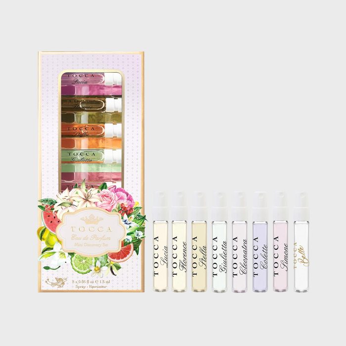 Perfume vials stand aligned; displayed in a decorative floral package, eight samples labeled with names: Stella, Florence, Cleopatra, Giulietta, Colette, Simone, Gia, Isabel.