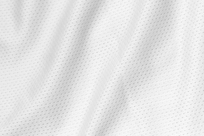 White color sports clothing fabric football shirt jersey texture and textile background.