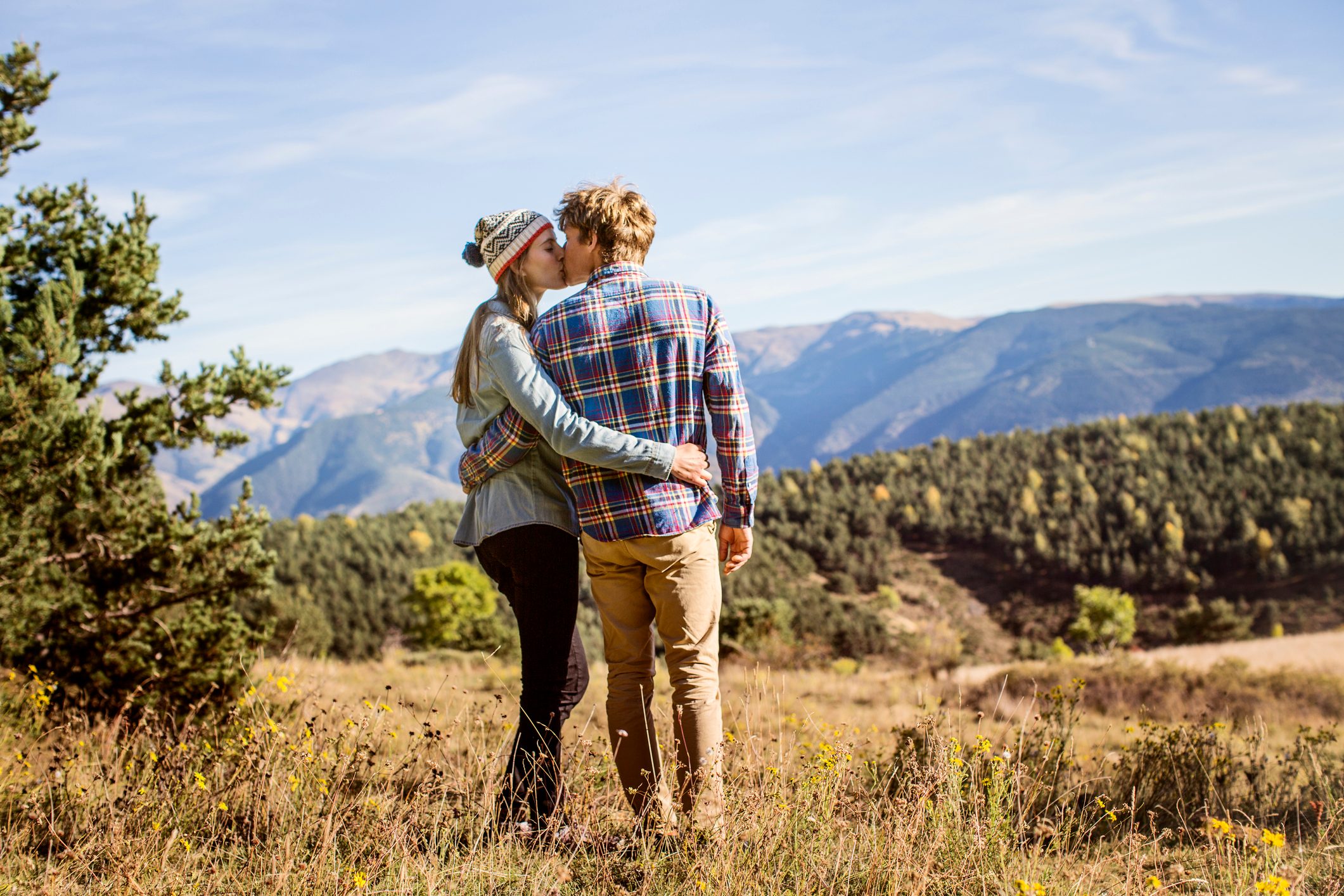 Couple kissing on field