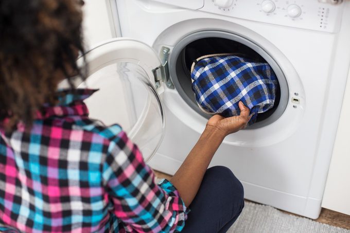 Young woman doing laundry
