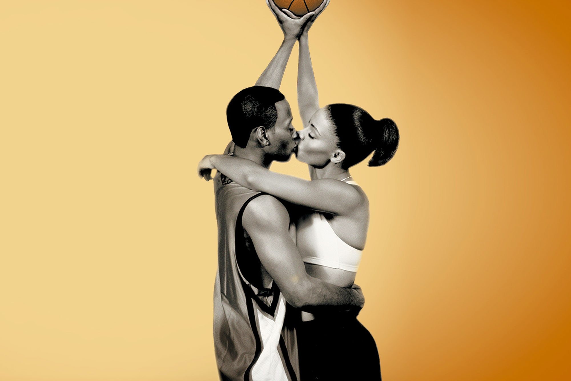 A couple kisses while holding a basketball overhead, set against a plain yellow-orange background.