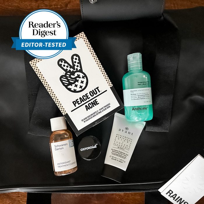 Skincare products arranged on a dark bag, including a 