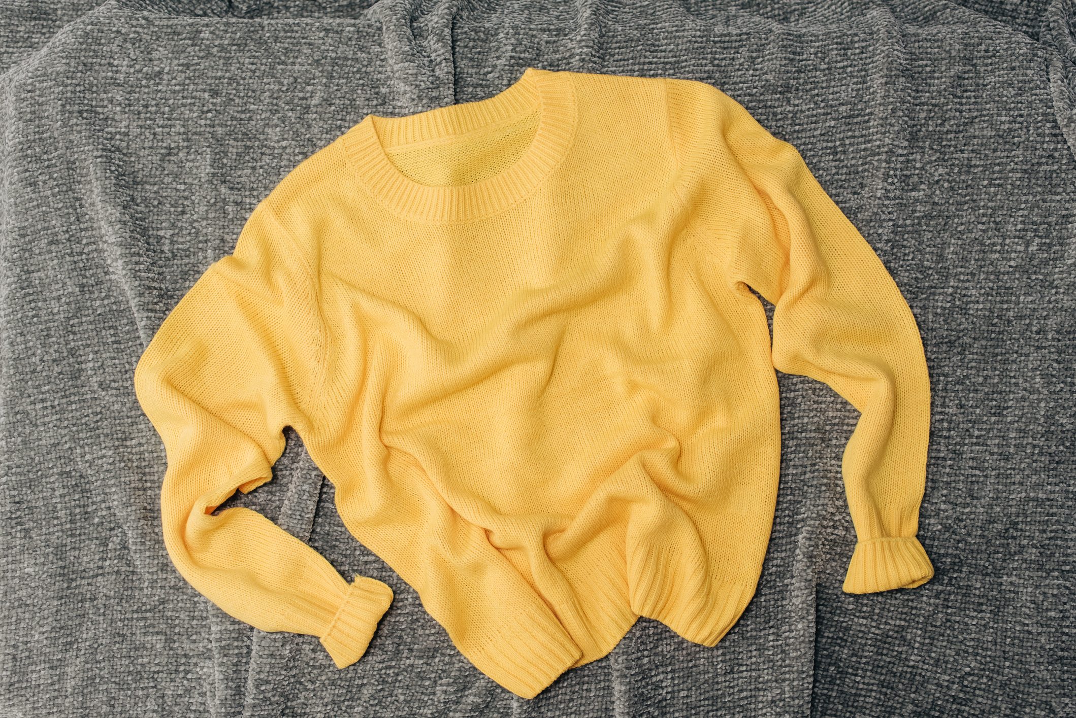 Female orange knitted sweater on white background top view flat lay. Fashion Lady Clothes Set Trendy Cozy Knit Jumper Autumn accessories. Female fashion look