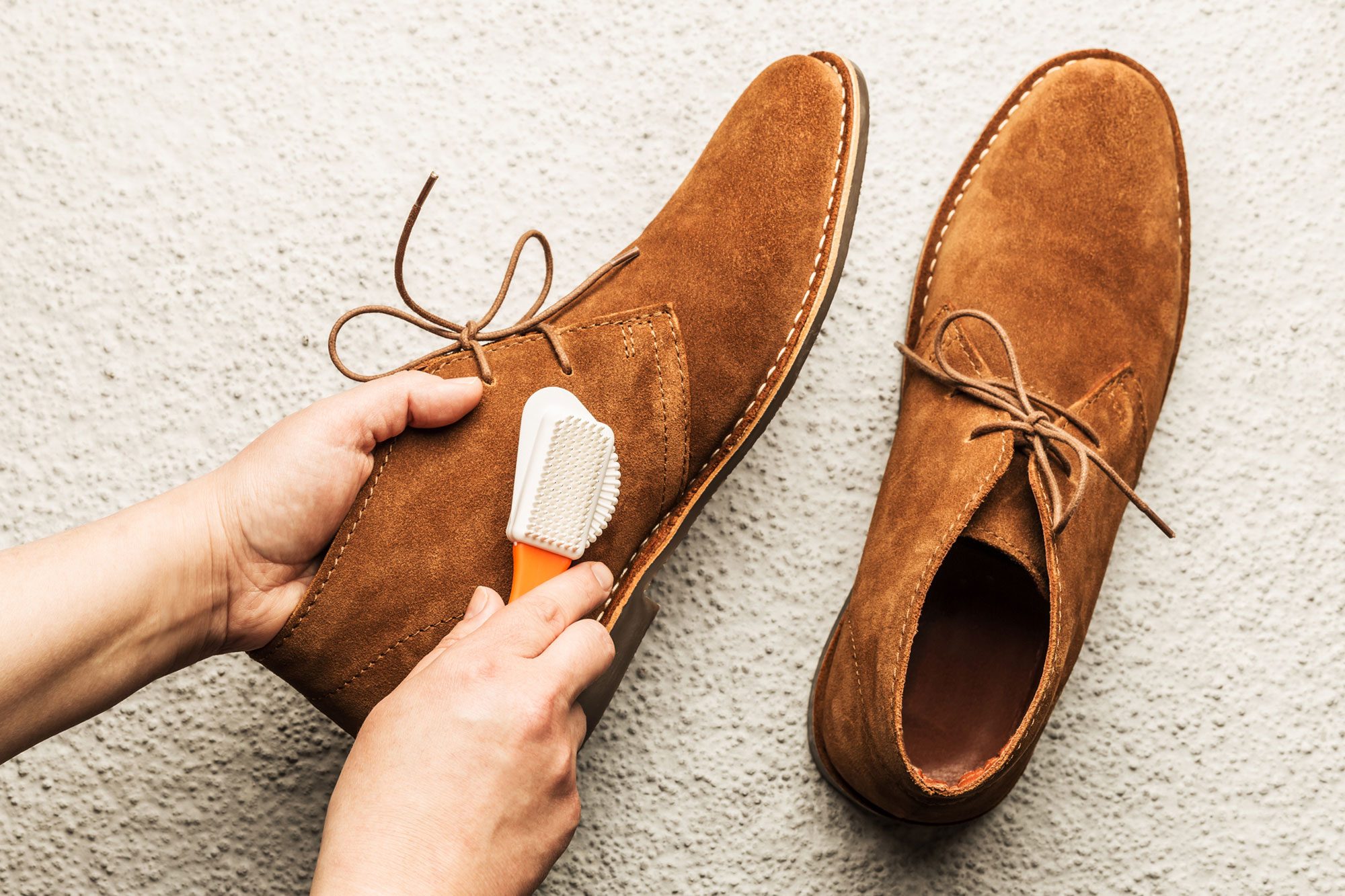 Hands Cleaning Mens Camel Suede Desert Shoes With A Brush