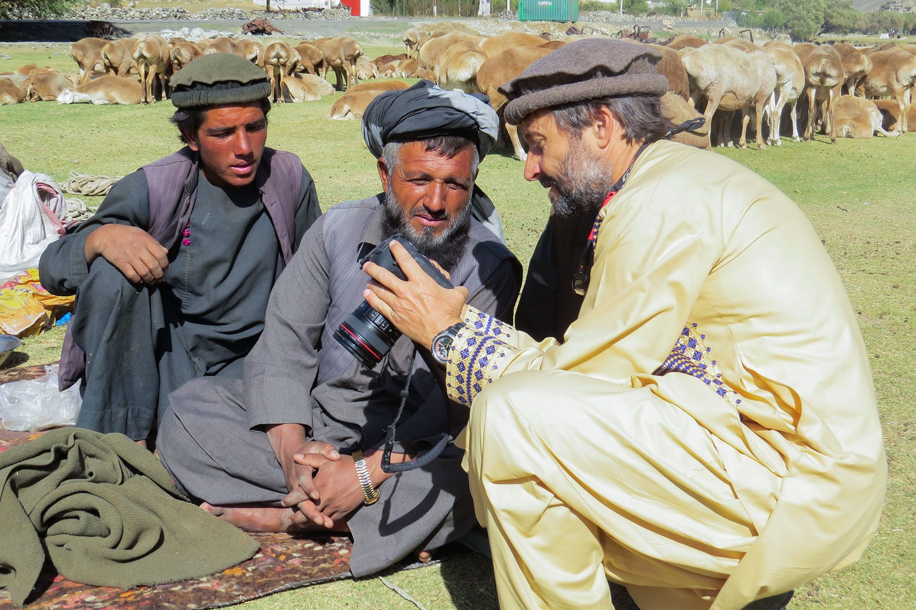 A Man showing other men his camera