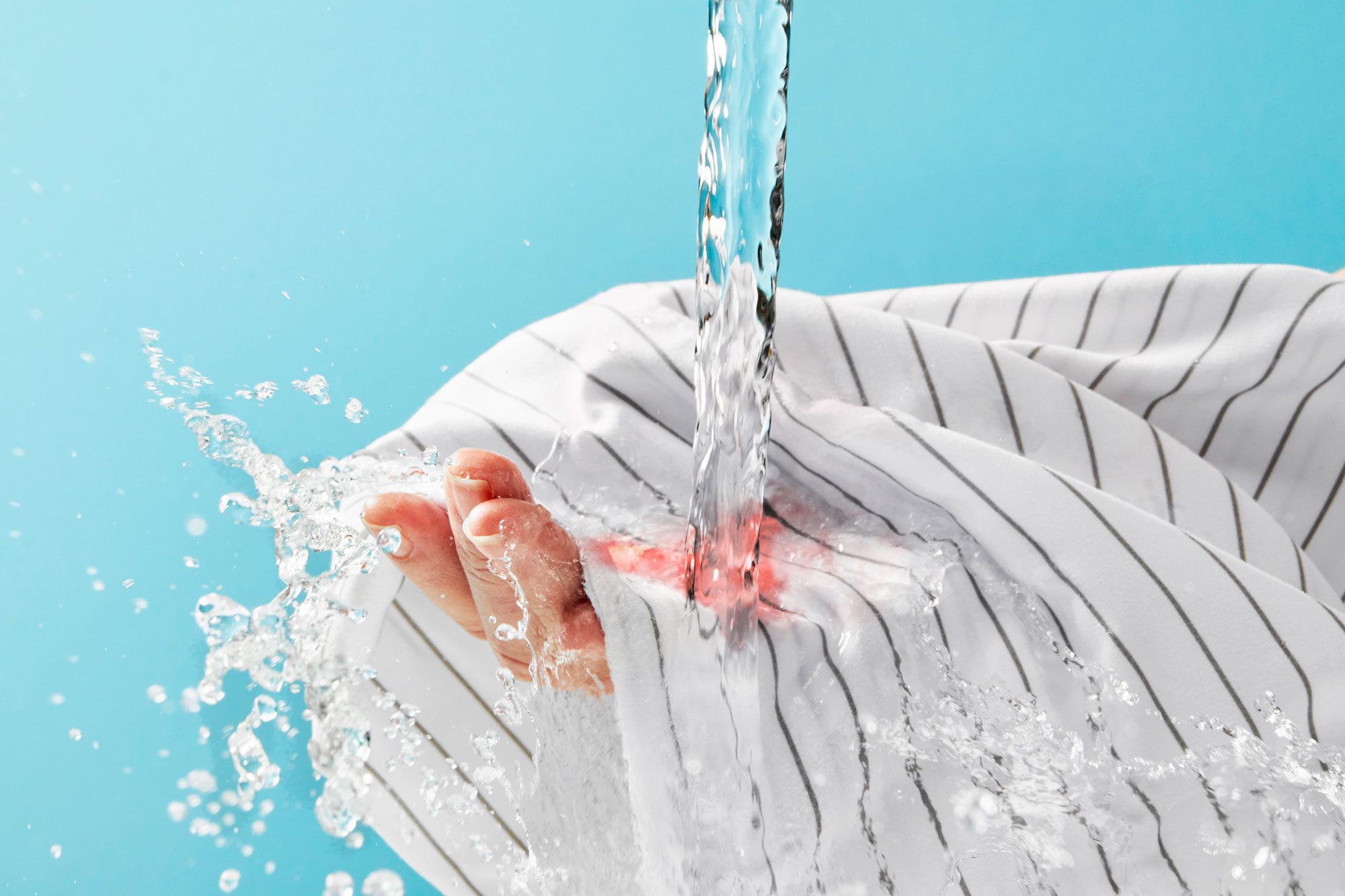 cold water running over blood stain on sheets