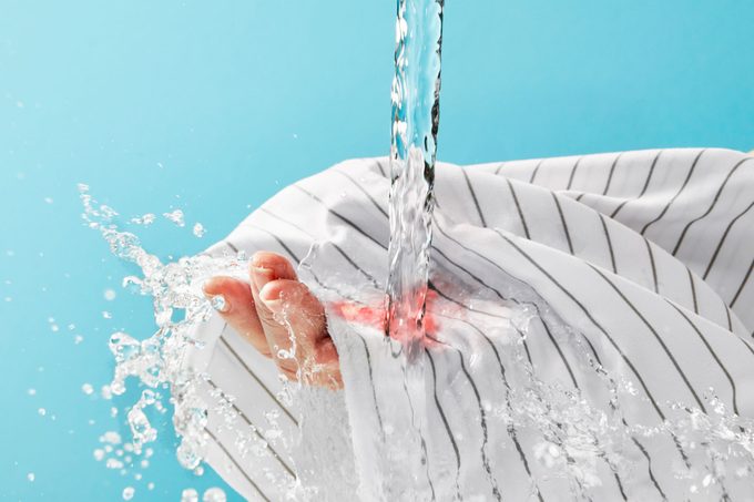 cold water running over blood stain on sheets