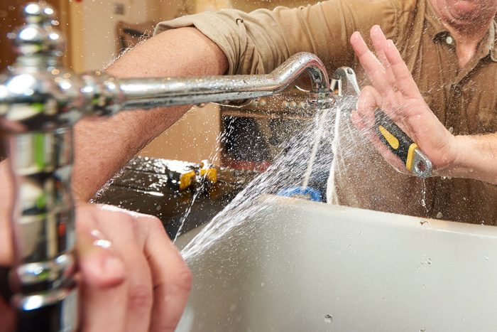 man getting sprayed by kitchen sink