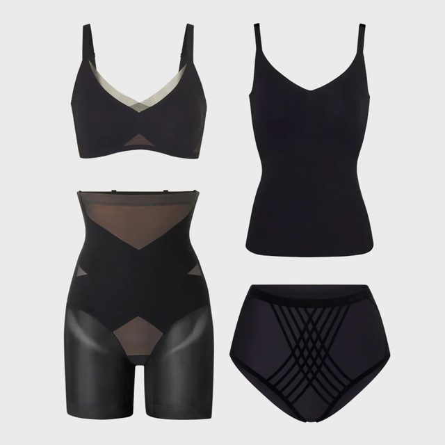 Black shapewear garments are displayed against a plain backdrop including a bra, cami, high-waisted shorts, and panties.
