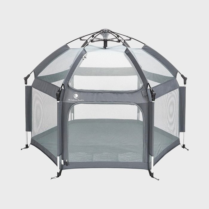 Hexagonal playpen standing with mesh panels, surrounded by minimalistic grey framing, against a plain white background.